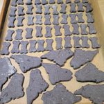 Dog treats shaped like bones on a baking tray